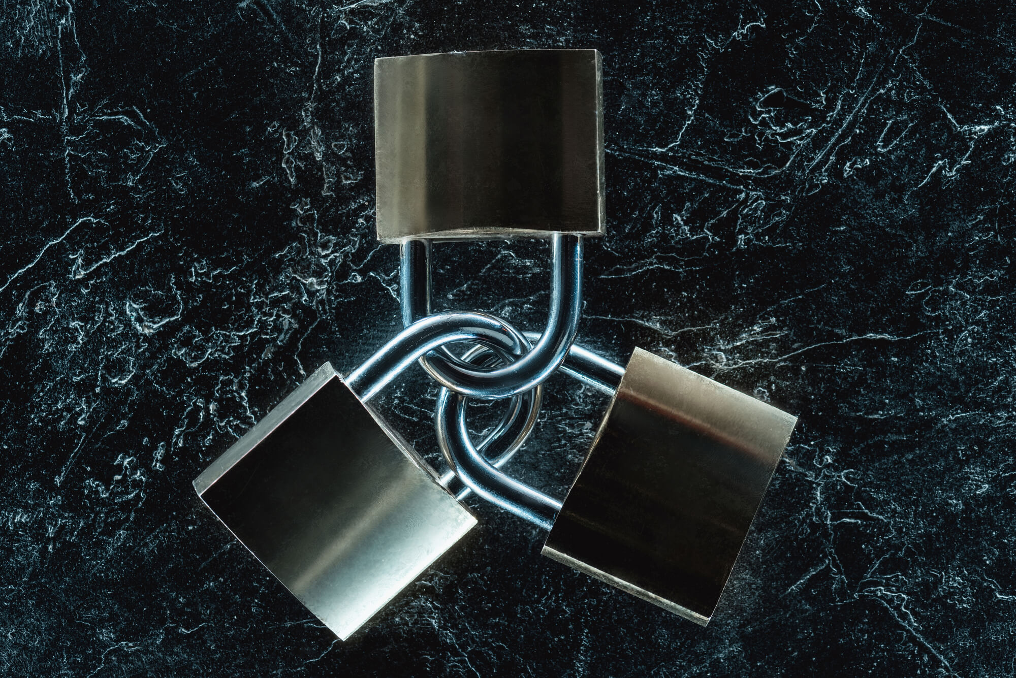 Layered security represented by three interlocking padlocks