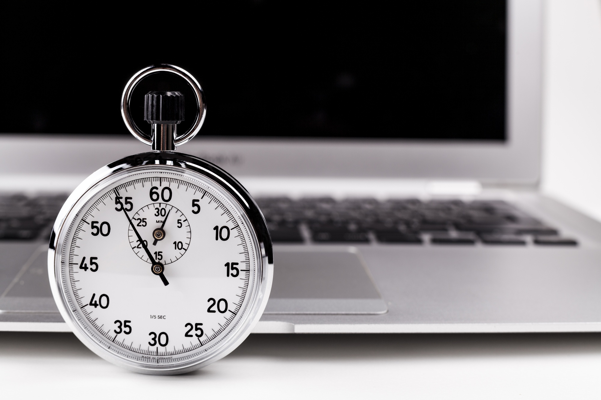 Slow computer being timed by IT Experts using a stopwatch