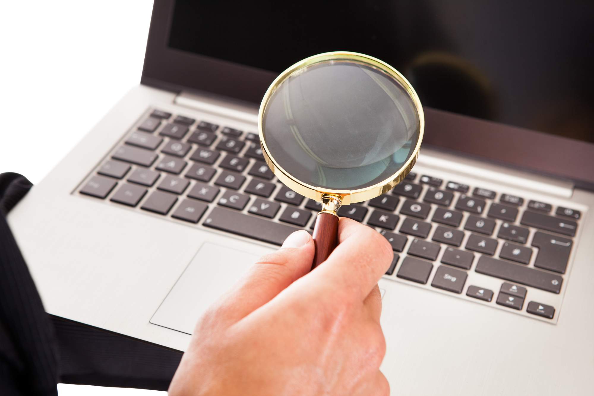 Magnifying glass and computer illustrating applications audits